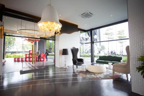 a living room with a chandelier and a lobby at ARTE MONT KIARA BY PSM Luxury Suites in Kuala Lumpur