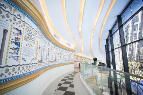 a hallway of a building with a checkerboard floor at ARTE MONT KIARA BY PSM Luxury Suites in Kuala Lumpur
