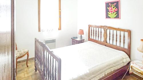 a bedroom with a wooden bed and a table at Villa avec piscine à Saint-Raphaël et vue sur la montagne in Saint-Raphaël