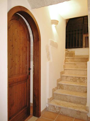 a hallway with a wooden door and stairs at Comfortable House with Fenced Garden - Surano - Fireplace in Surano