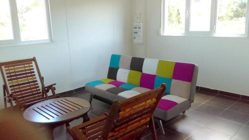 a living room with a couch and a table at Maison charmante à Macouria avec jardin et climatisation. in Guenouillet