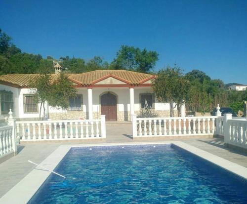 a house with a swimming pool in front of a house at Charming chalet in Prado del Rey with private pool in Prado del Rey