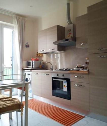 a kitchen with a stove and a table in it at Modern Apartment in the Heart of Rome, 42 m², Parking Included in Rome