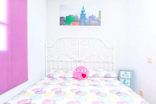 a pink toy on a bed in a bedroom at Charming House in Costa Calma with Mountain View and Terrace in Costa Calma