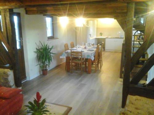 une salle à manger avec une table et des chaises dans une pièce dans l'établissement Maison charmante au Theil-en-Auge, à Le Theil-en-Auge