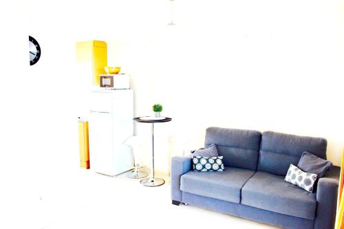 a living room with a blue couch with pillows at Cozy apartment in Dénia, 40 m² with shared pool in Denia