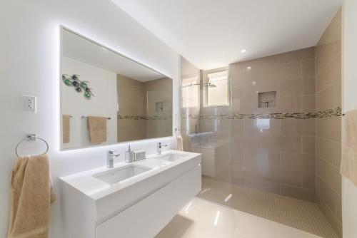 a white bathroom with a sink and a mirror at Westmoreland Hills - Mount Standfast - St James - Full Gym Membership in Saint James