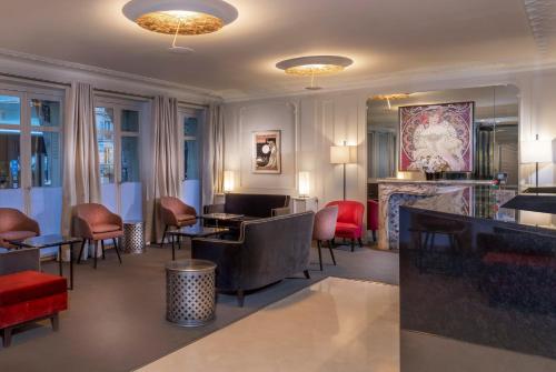 a restaurant with chairs and tables and a fireplace at Elysées Ceramic in Paris