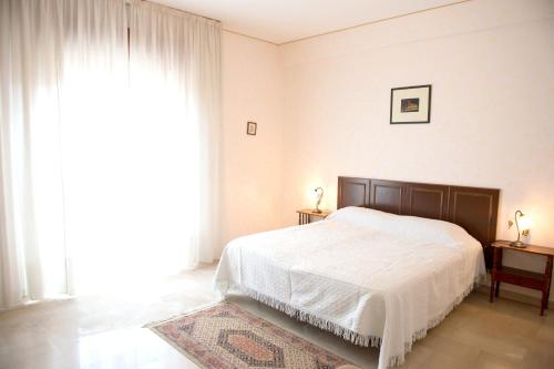a bedroom with a bed and a large window at 2 bedrooms appartement with terrace at Vita in Vita