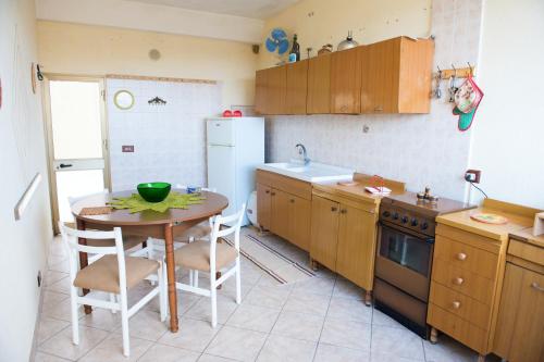 a small kitchen with a table and a refrigerator at 2 bedrooms appartement with terrace at Vita in Vita