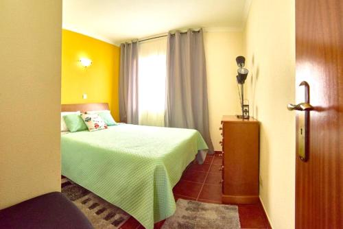 a small bedroom with a bed and a window at One bedroom appartement with sea view terrace and wifi at Lajes Do Pico in Lajes do Pico