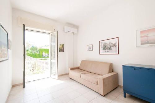 a living room with a couch and a window at Charming apartment in Vieste with balcony and garden view in Vieste