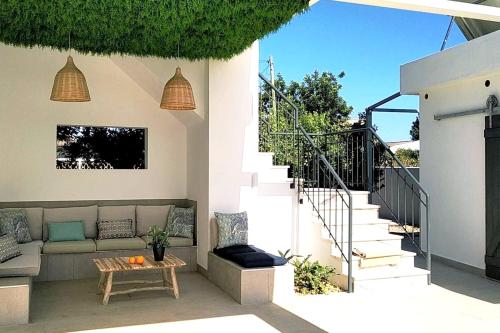 a patio with a couch and a table and stairs at Modern apartment in Estói with shared pool. in Estói