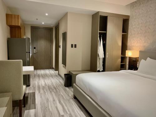a hotel room with a bed and a desk at Capitol Hill Hotel and Suites in Angeles