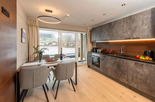 a kitchen with a table and chairs in a room at Appartements Wehrhof by Schladmingurlaub in Schladming