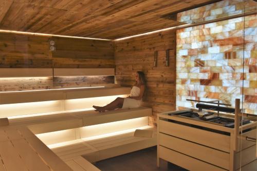 a woman sitting in the inside of a sauna at Schlosspark Mauerbach - Adults only in Mauerbach