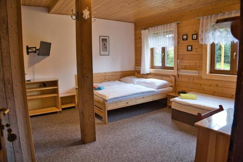 A bed or beds in a room at Penzion Pohádka