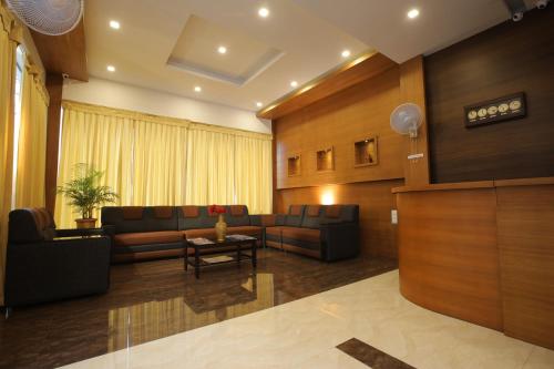 a living room with a couch and a table at The Patio Thekkady in Thekkady