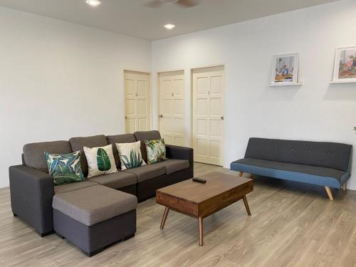 a living room with a couch and a coffee table at Grace Homestay Tawau in Tawau