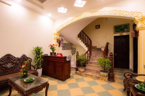 a living room with a staircase and a stair case at Lys Homestay in Ninh Binh