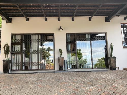 an entrance to a house with glass doors at Bokamoso Views in Rustenburg