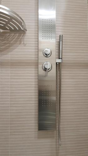 a metal door with a shower in a bathroom at b&b 1930 in Rome