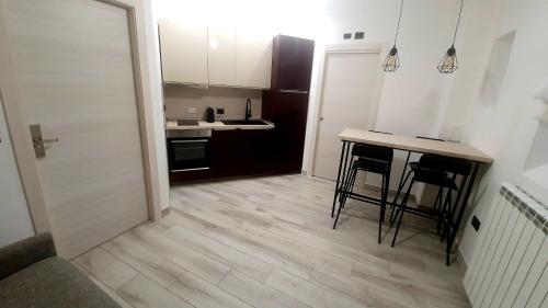 a kitchen with a counter and a table and chairs at b&b 1930 in Rome