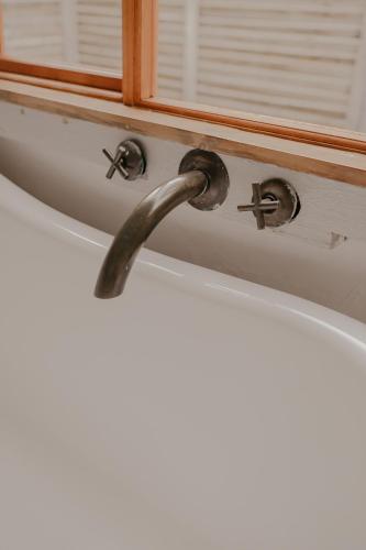 a bathroom drawer with a handle and a window at Qambathi Mountain Lodge in Kamberg Valley