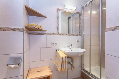 a bathroom with a sink and a shower at Bergbauernhof Seetalhof in Hollersbach im Pinzgau
