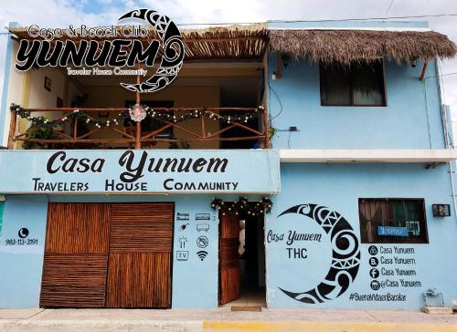 a blue building with a sign for a restaurant at Casa & Beach Club Yunuem in Bacalar