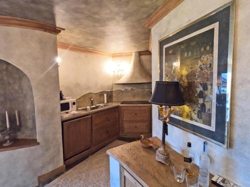 a kitchen with a table with a lamp on it at Beautiful apartment over the mountain in Crans-Montana