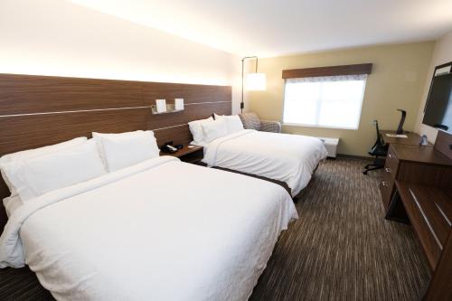a hotel room with two beds and a flat screen tv at Holiday Inn Express Atlanta - Northeast I-85 - Clairmont Road, an IHG Hotel in Atlanta