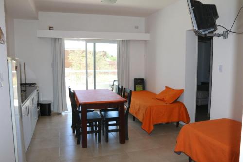 a kitchen and dining room with a table and chairs at Departamentos LG in Las Grutas