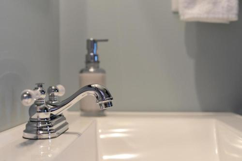 a bathroom sink with a chrome bathroom faucet at Bambury's Hillside Chalets in Rocky Harbour