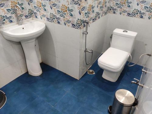 a bathroom with a toilet and a sink at HOTEL CENTRAL SQUARE "A Couple Friendly Hotel" in Muzaffarpur