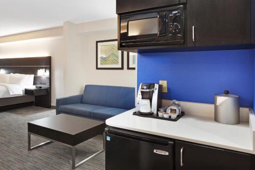 a hotel room with a kitchen and a living room at Holiday Inn Express & Suites Culpeper, an IHG Hotel in Culpeper