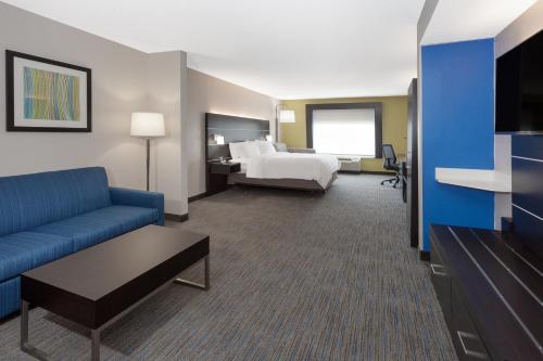 a hotel room with a bed and a couch at Holiday Inn Express & Suites Culpeper by IHG in Culpeper