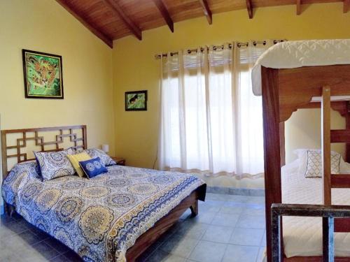 a bedroom with a bed and a window at Mango Tree Villas in Coronado