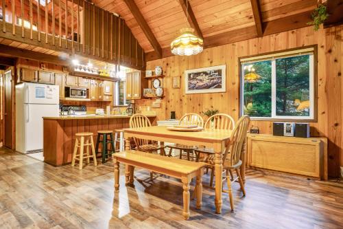 a kitchen and dining room with a table and chairs at The Chalet on Lopez in Islandale