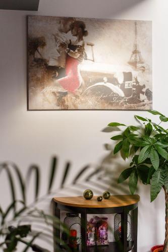 a table in a room with a picture on the wall at Villa Montana in Braşov