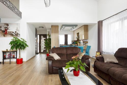a living room with two couches and a table at Villa Montana in Braşov