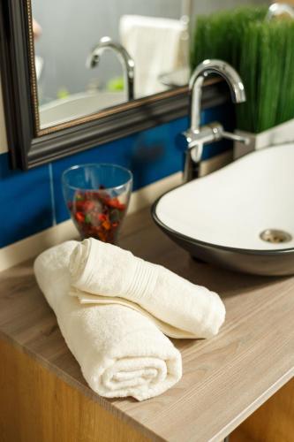 a white towel on a counter next to a sink at Villa Montana in Braşov