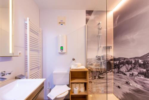 uma casa de banho com um chuveiro, um WC e um lavatório. em Damülser Horn em Damüls