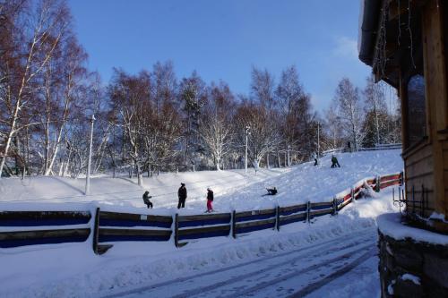 a group of people skiing down a snow covered slope at Insh Hall Rooms at Loch Insh in Kincraig