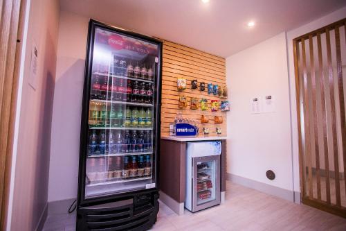 a refrigerator filled with lots of drinks in a room at Holiday Inn Express & Suites Rehoboth Beach by IHG in Rehoboth Beach