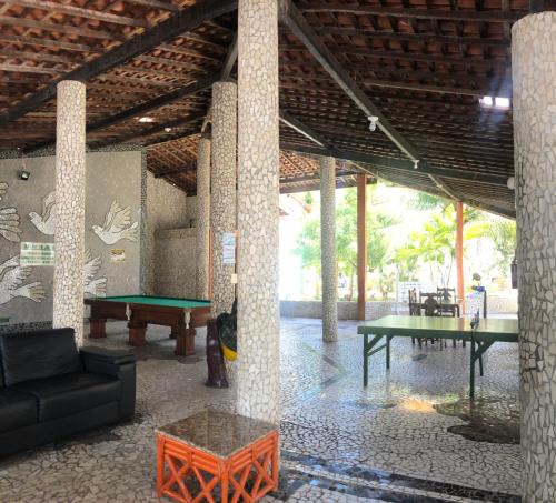 a living room with a ping pong table and a pool table at Village Galés de Maragogi in Maragogi