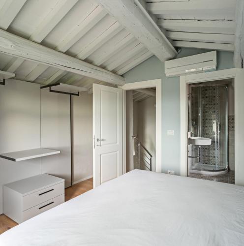 a bedroom with a white bed and blue walls at Podere GIUSTI in Reggello