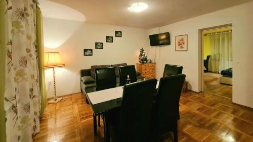 un comedor con sillas y una mesa y una habitación en Apartment Garden, en Slunj