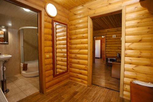 a bathroom with a shower and a toilet in a room at Knyazhya Rechka in Tver