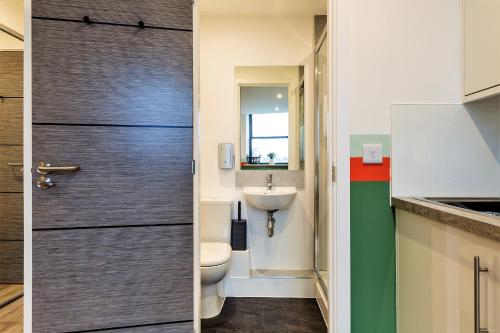 a bathroom with a toilet and a sink at Your Apartment I Clifton Village in Bristol